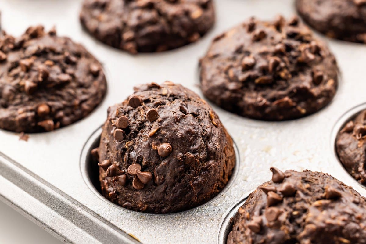 Chocolate banana oat muffins cooling in muffin tin.