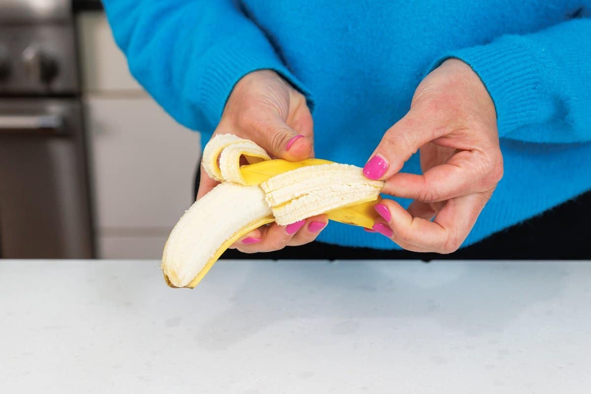 Liz peeling a banana.