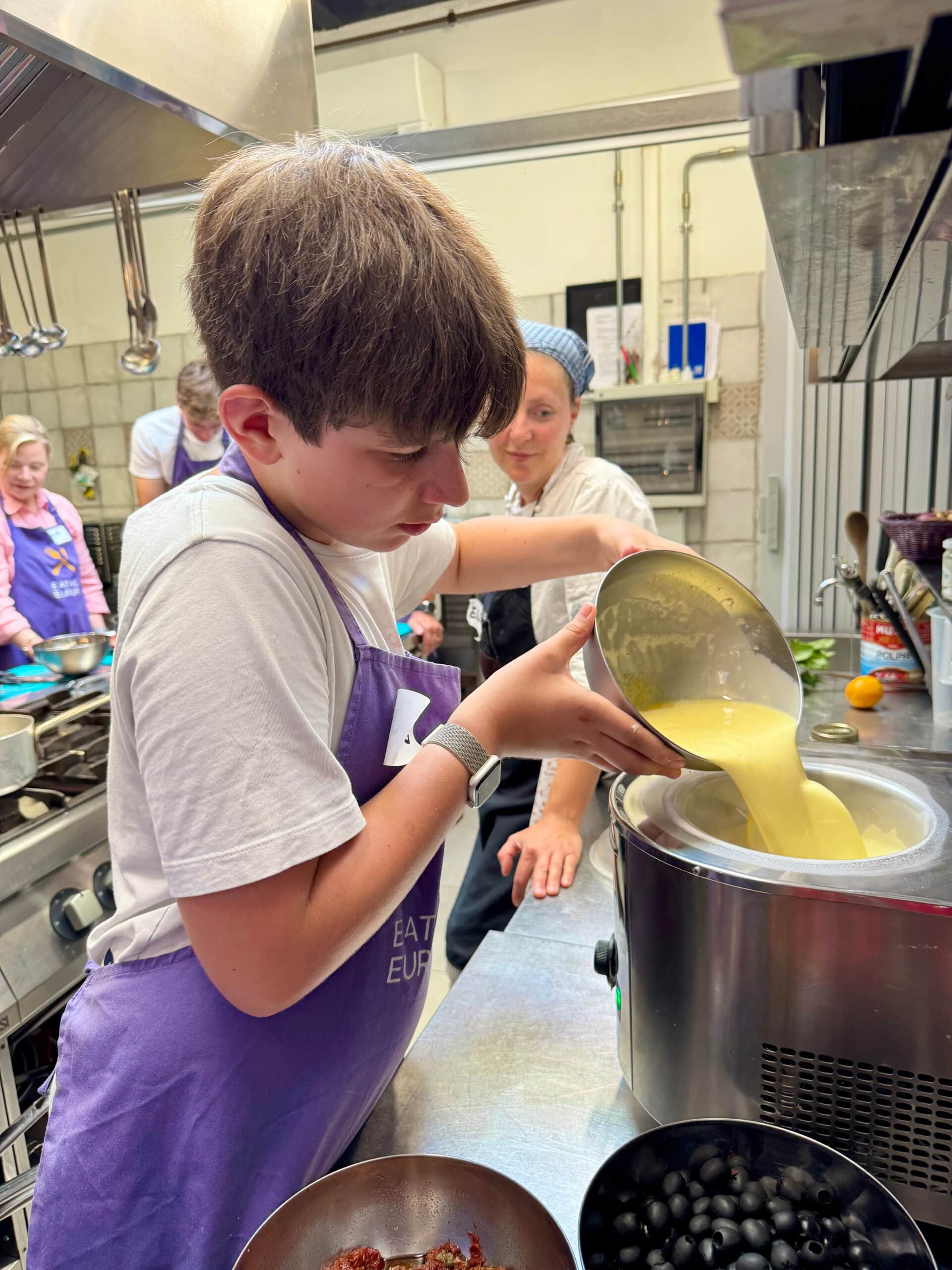 Liz's son pouring gelato into mixer.