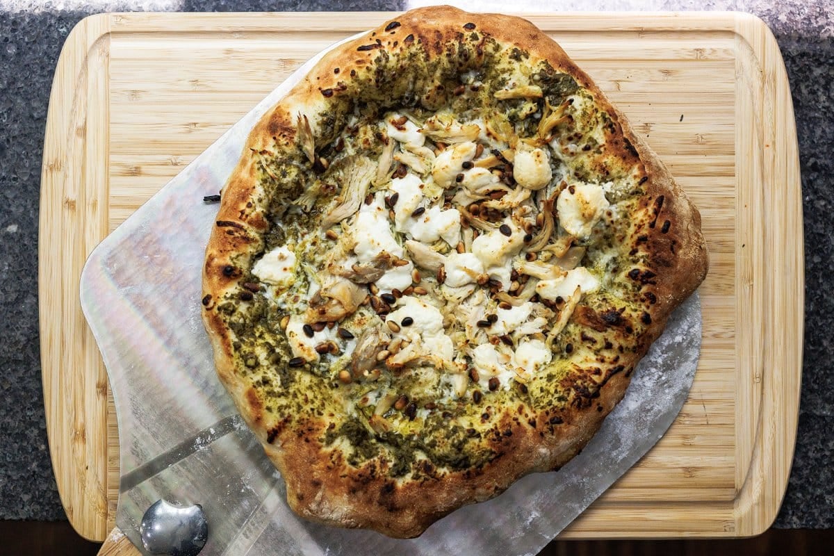 Cooked pesto chicken pizza removed from the oven.