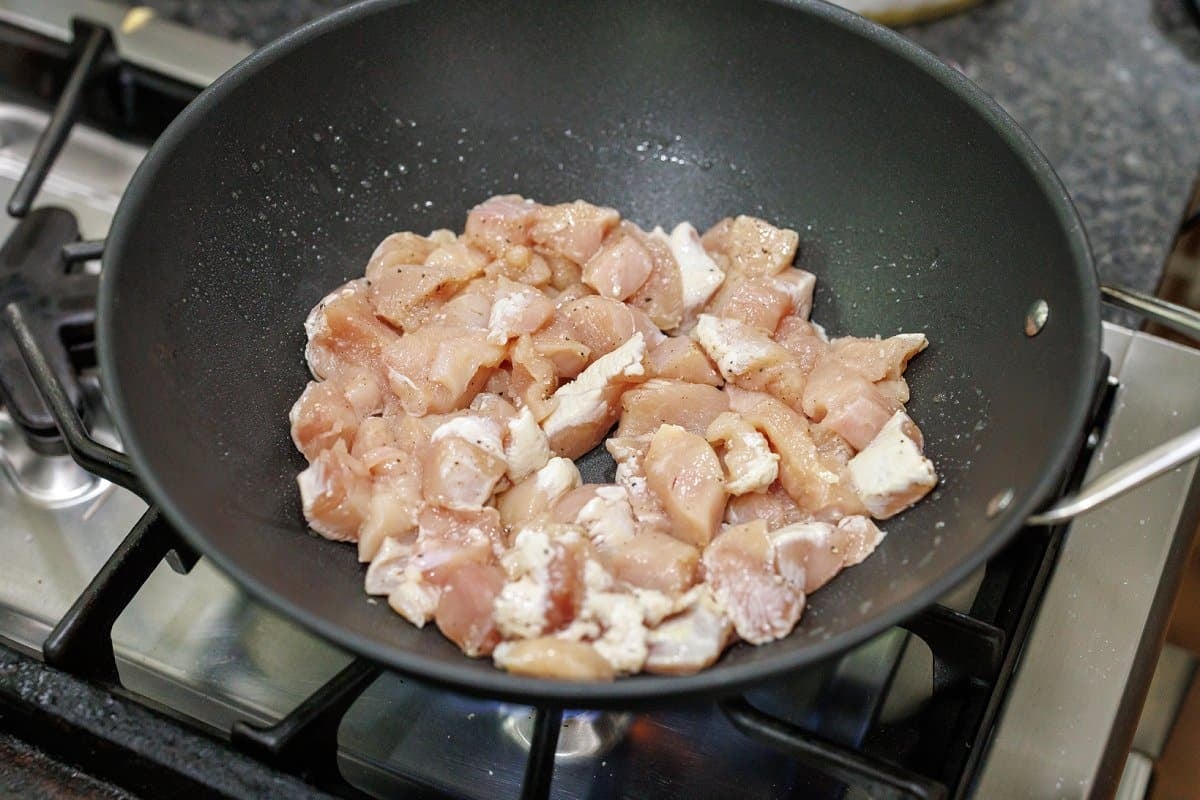 Cooking chicken in wok.
