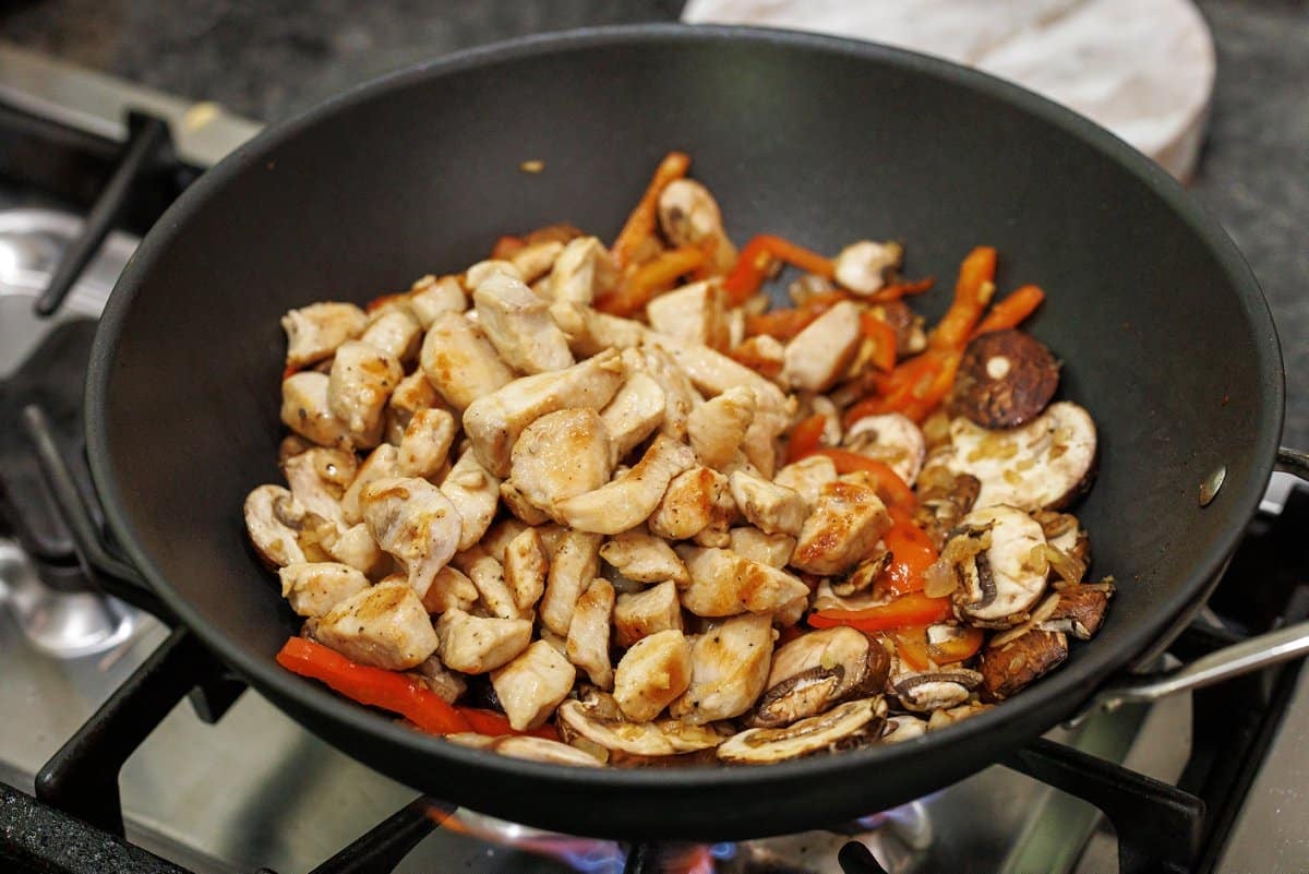 Mushrooms added to wok.