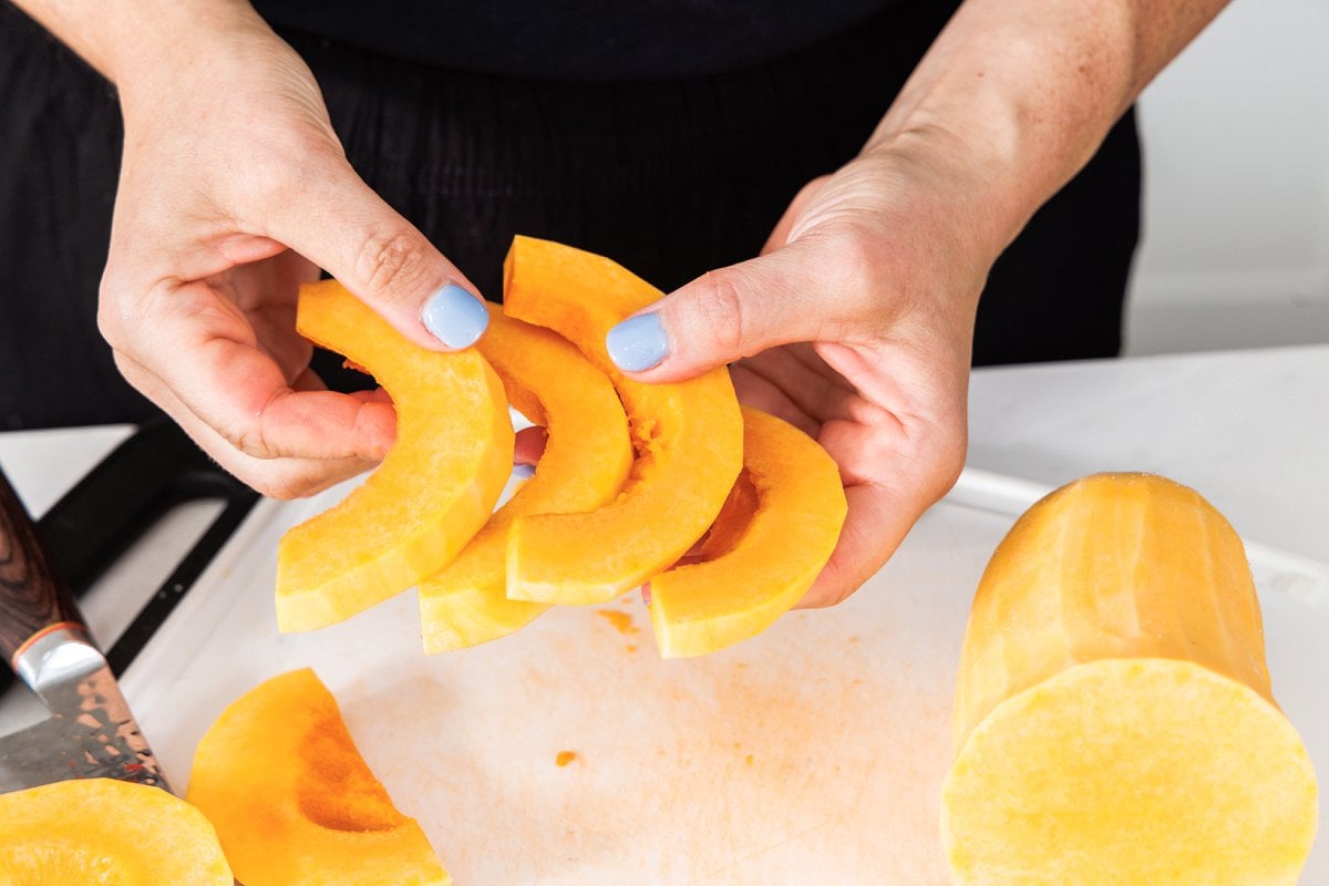 Liz holding slices of butternut squash.