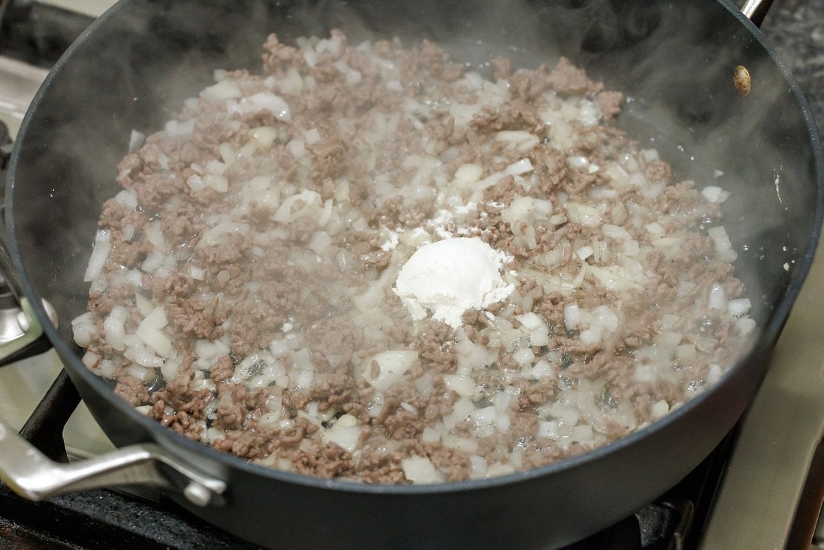 Cooking onion with meat and flour.