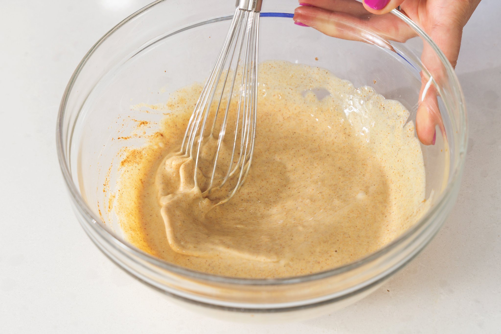 Whisking together shawarma marinade.