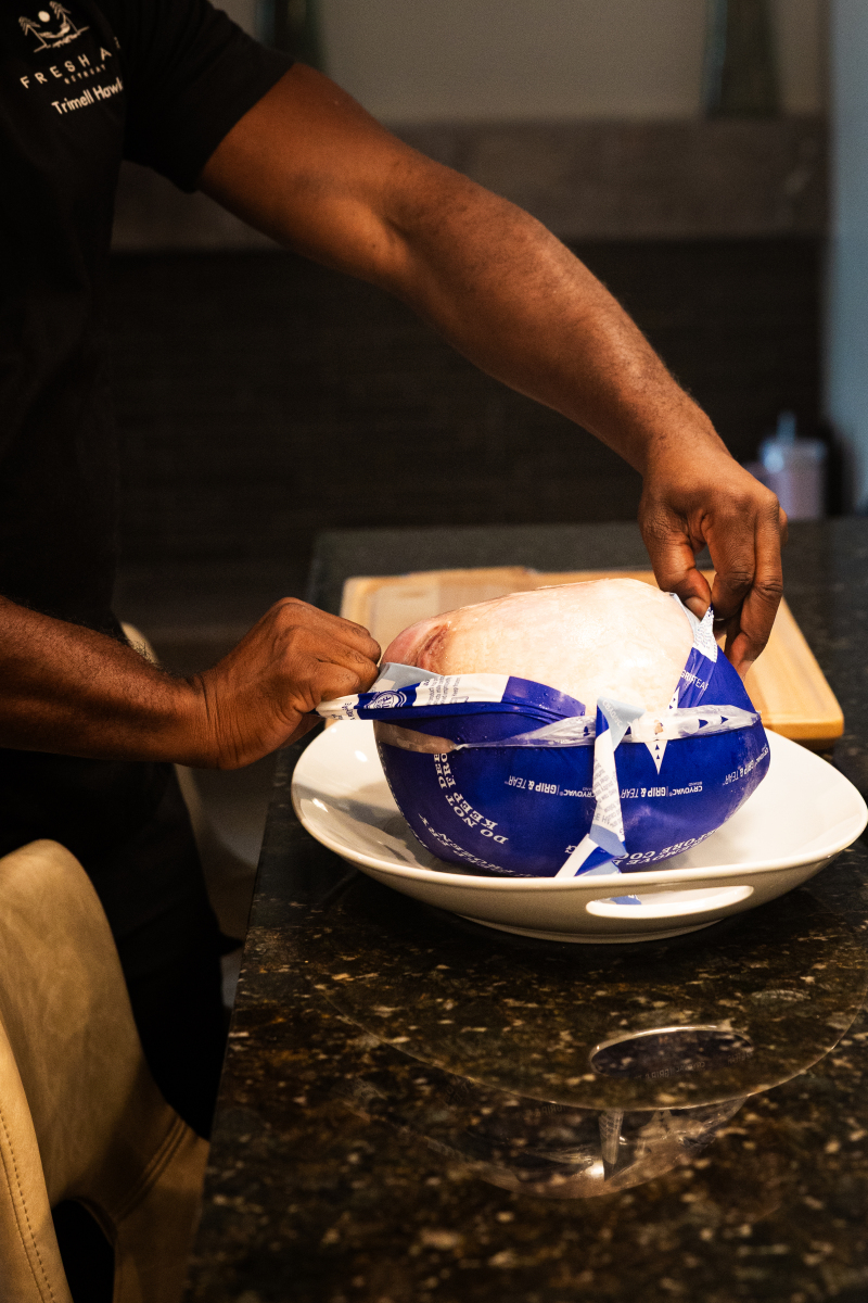 Unwrapping Butterball's frozen whole turkey.