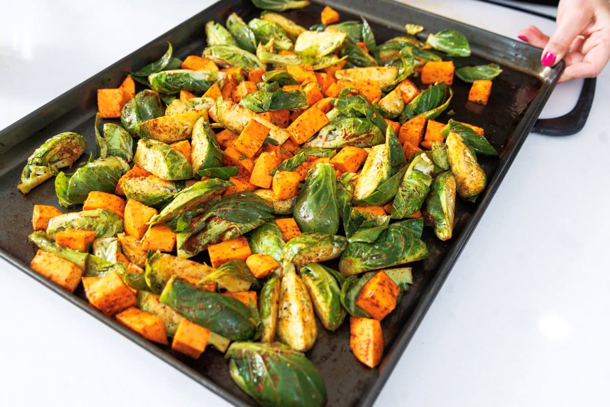 Chopped fall veggies laid out on a sheet pan.