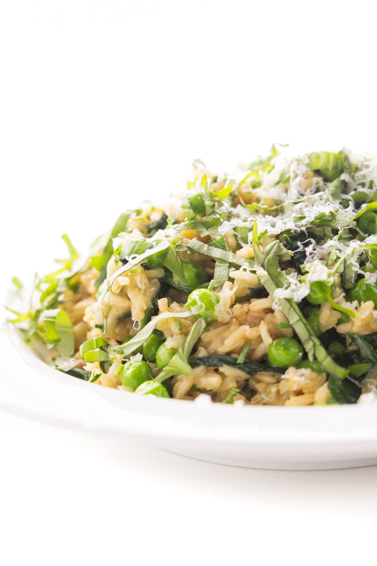 Brown rice with spinach and herbs on a plate.