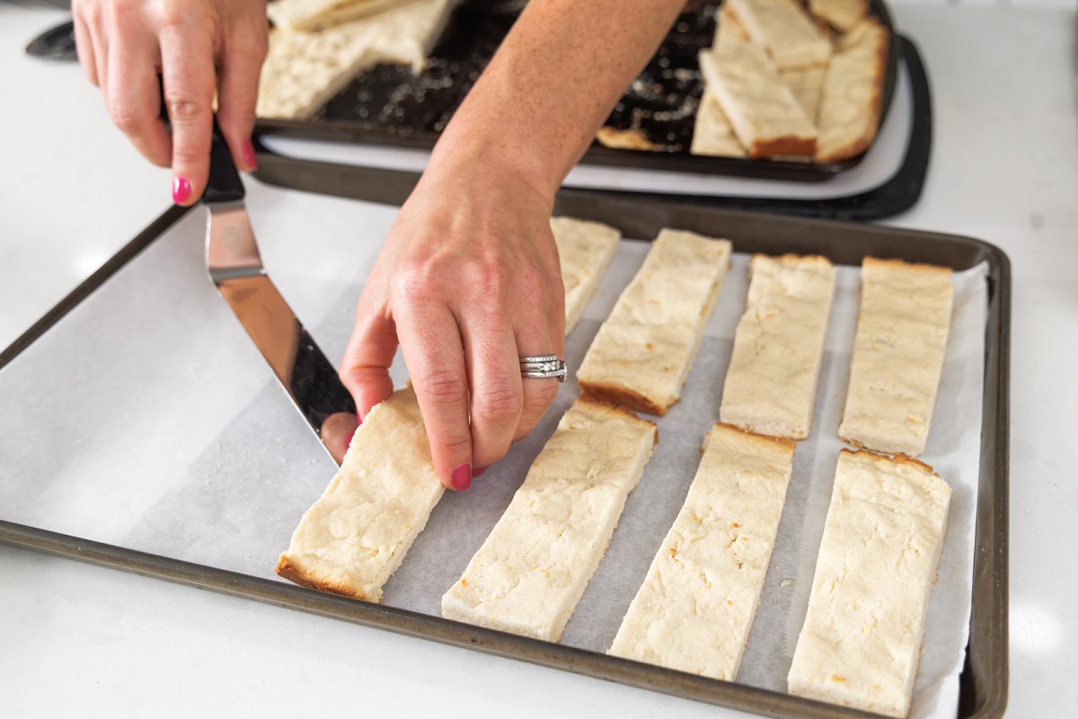 Laying shortbread cookies out on wax paper.