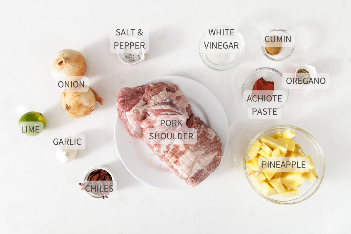 Labeled ingredients for slow cooker tacos al pastor on a white counter.