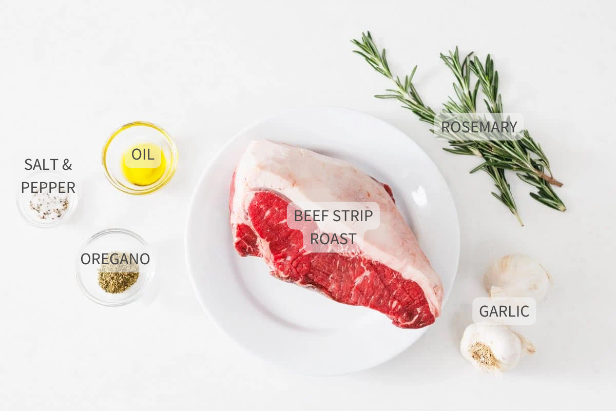 Labeled ingredients for garlic and rosemary studded beef roast on a white counter.